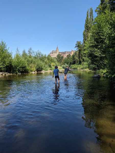 Kinder gehen durch den Fluss Ahr.
